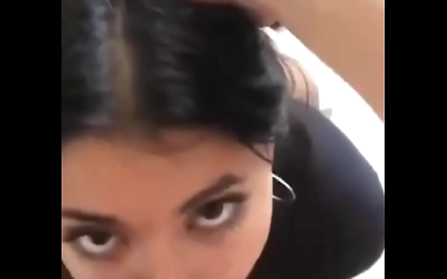 Bending over to reveal a juicy round latina booty in tight jeans