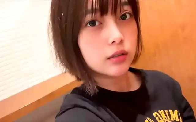 Moaning loudly as she touches herself next to the toilet