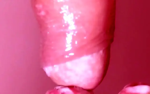 Close-up view of a pretty Japanese face deepthroating with passion